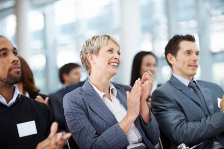 Business colleagues clapping her hand while at a seminar